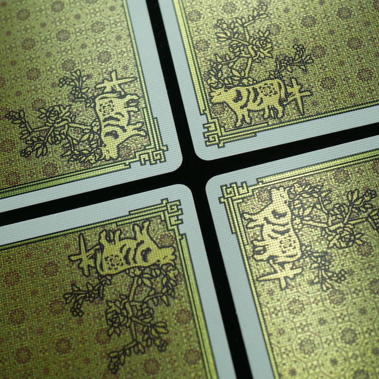 The backs of the Zodiac 2021 - Year of the Ox deck, showing cold foil card backs. Intricate and precise.