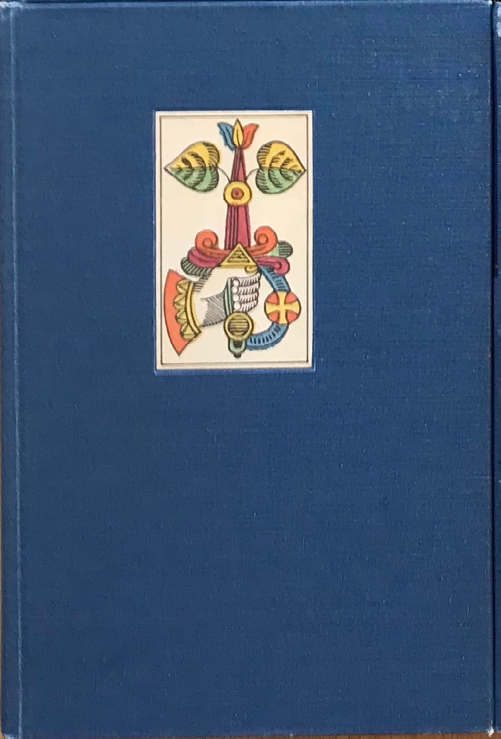 Blue clothbound volume with a facsimile playing card mounted on the front cover.